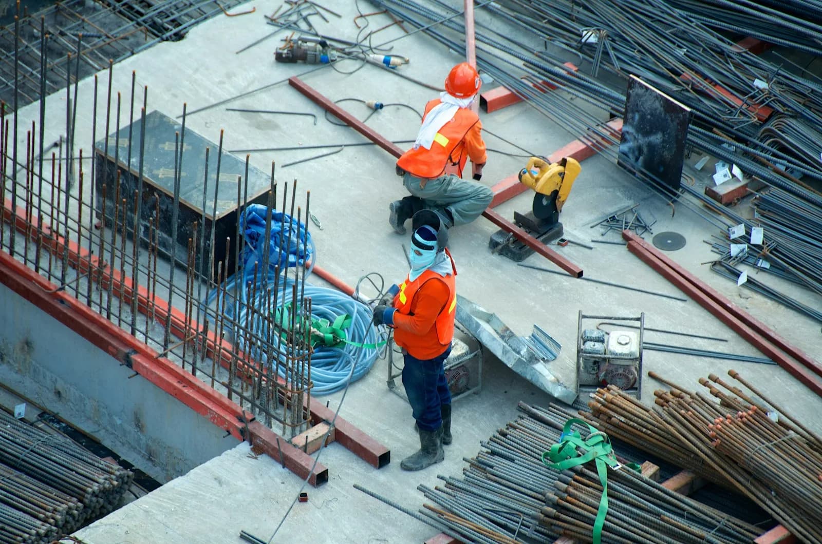 Crew working reinforcement steel where boom trucks feed material