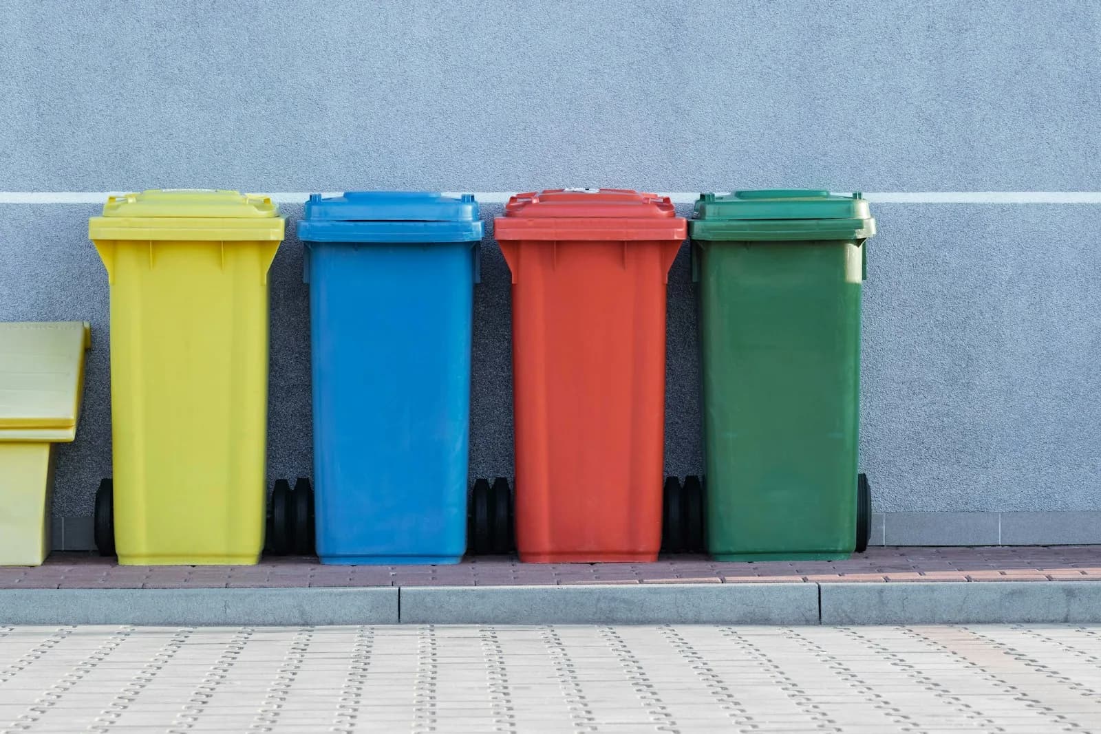 Color-coded segregation bins lined against a facility wall