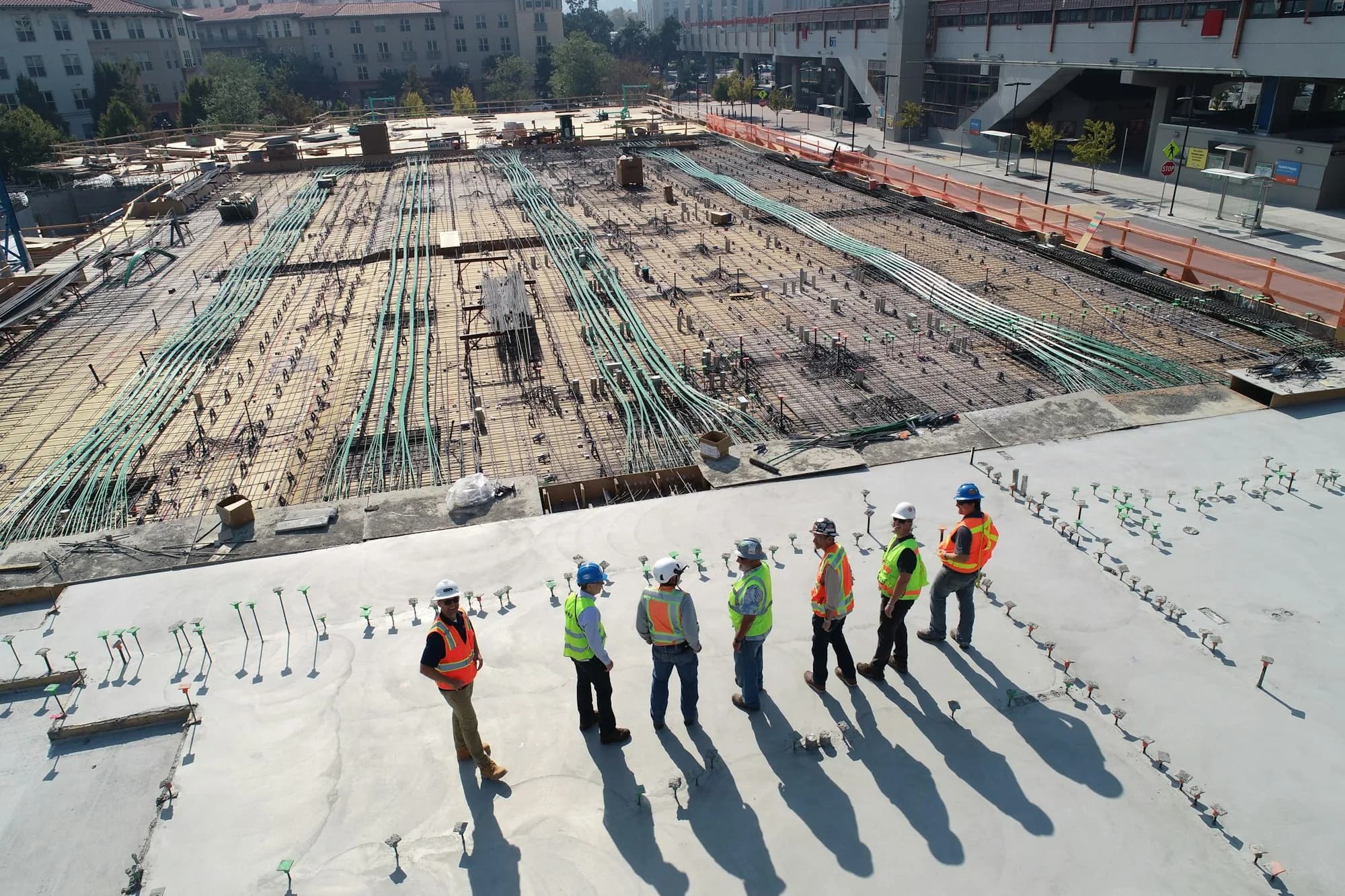 Supervisors reviewing an active construction deck